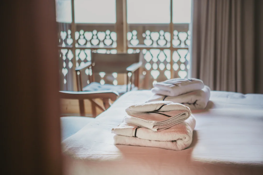 Fresh towels carefully arranged on a prepared chalet bed